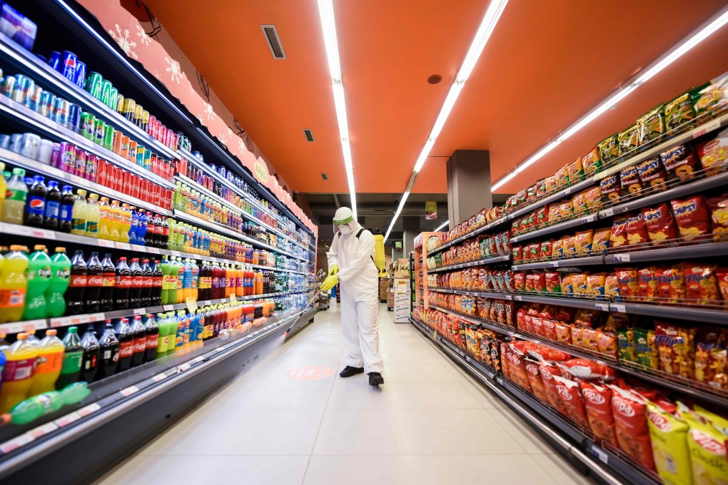 A worker disinfects the floor of a supermarket as a preventive measure against the spread of coronavirus. So much of the infrastructure of our civilisation is maintained by low-paid workers. Photo: AFP