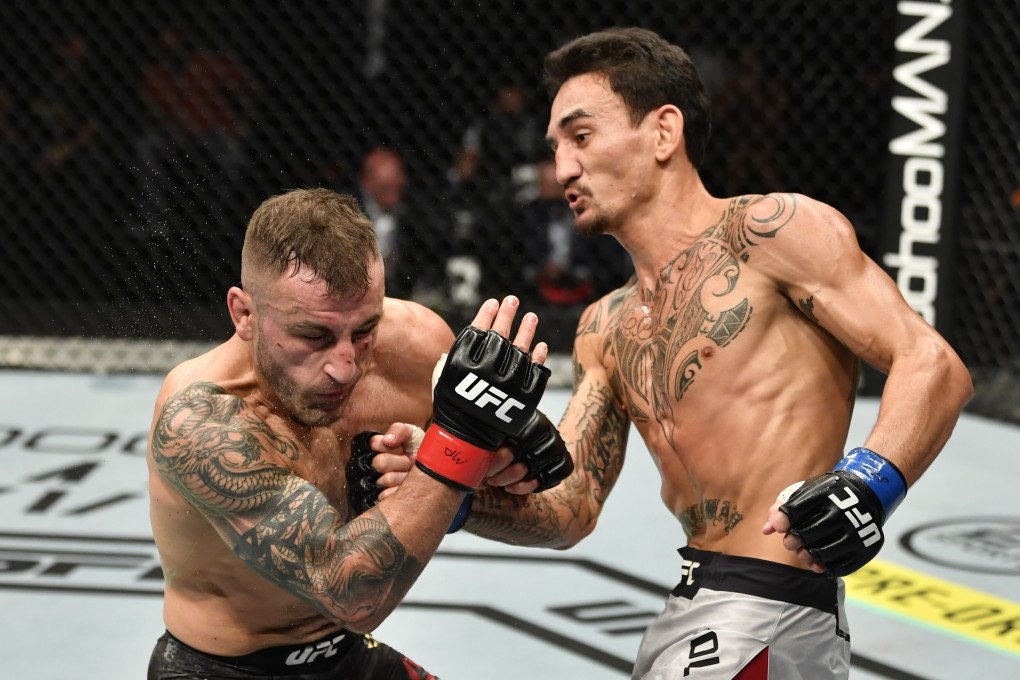 Max Holloway punches Alexander Volkanovski in their UFC featherweight title rematch at UFC 251. Photo: Jeff Bottari/Zuffa LLC via USA TODAY Sports