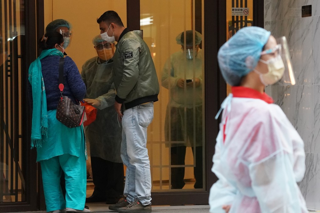 A staff member in protective gear waits for arriving guests at the Ramada Hong Kong Grand in North Point, a designated quarantine hotel, on December 21. The Hong Kong government has since tightened its quarantine requirements for arrivals. Photo: Felix Wong