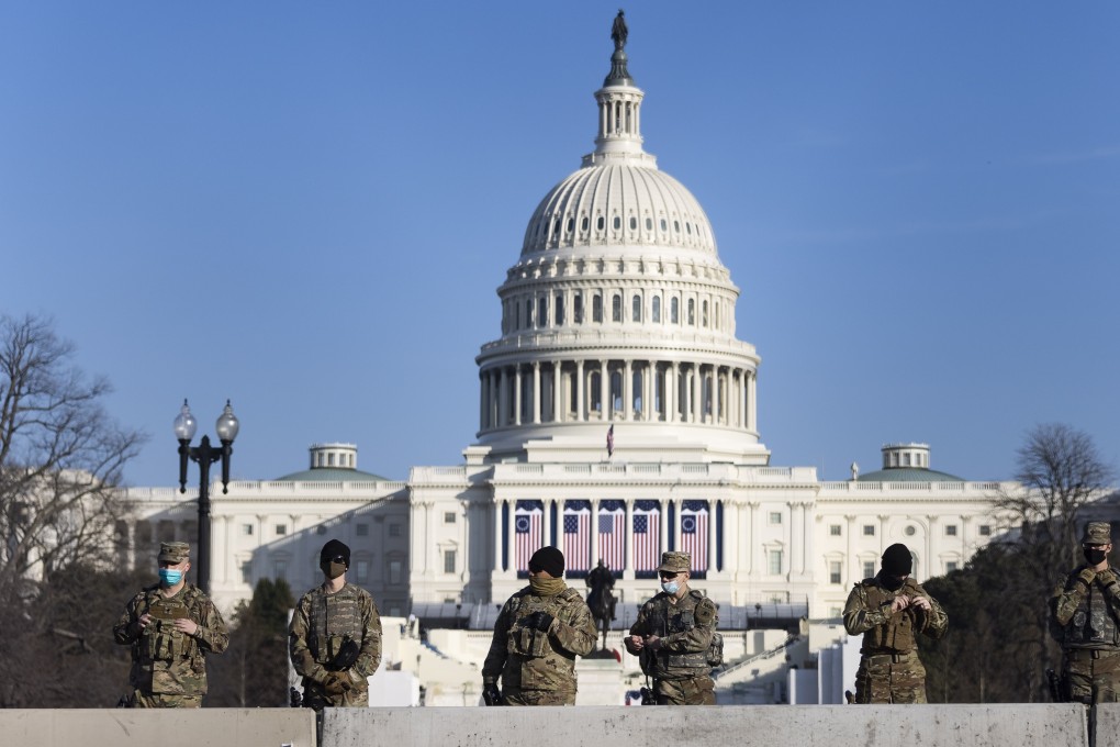 National Guard soldiers are seen on the grounds of the US Capitol building ahead of Donald Trump’s impeachment vote in the House on Wednesday. Photo: EPA-EFE