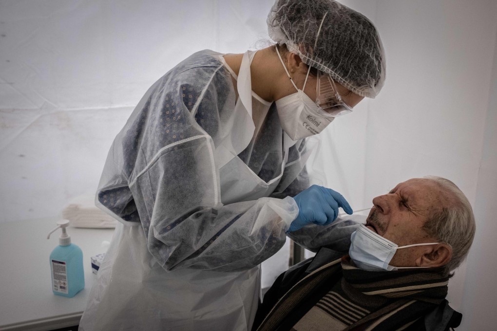 A health worker in protective gear conducts a Covid-19 test in Saint-Etienne, France on Wednesday. Photo: AFP