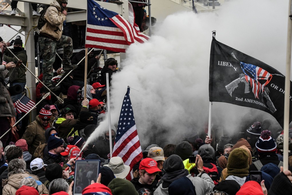 A Trump supporter sprays smoke during a protest outside the Capitol building in Washington on January 6. Photo: Reuters