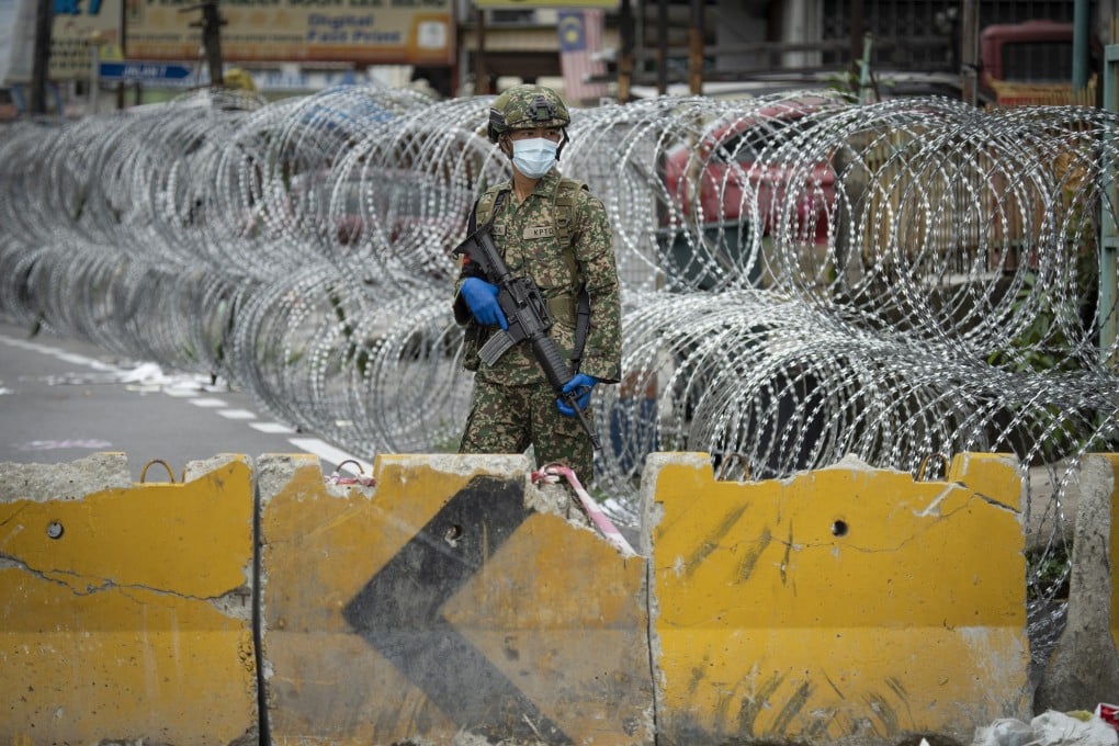 A soldier on guard in the locked-down area of Selayang Baru on the outskirts of Kuala Lumpur in April 2020. Photo: AP