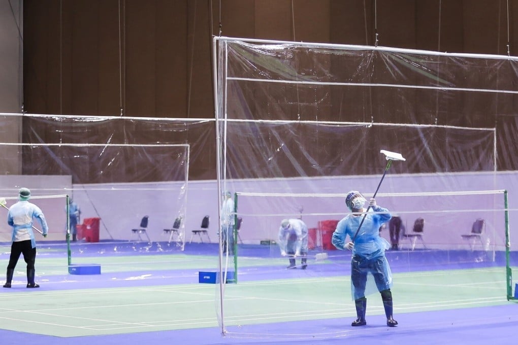 Workers disinfect the courts where the Yonex Thailand Open is taking place at the Impact Arena in Bangkok. Photo: Reuters