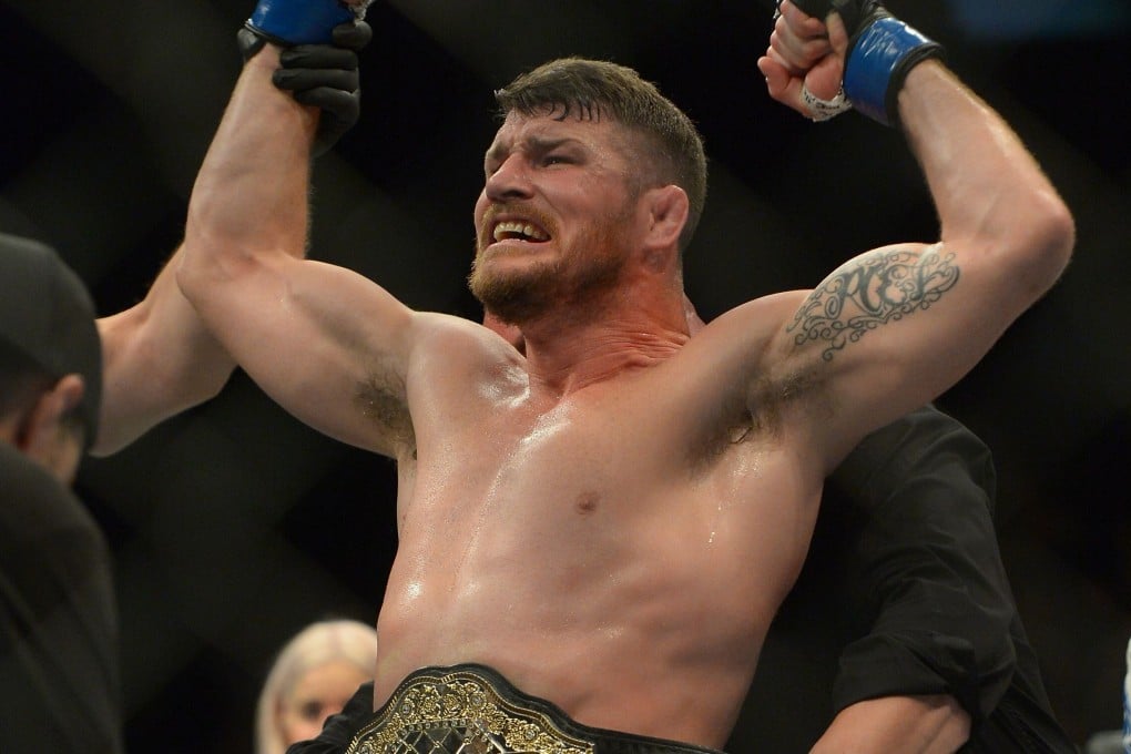 Michael Bisping reacts after knocking out Luke Rockhold to win the UFC middleweight title at UFC 199 on June 4, 2016. Photo: AFP