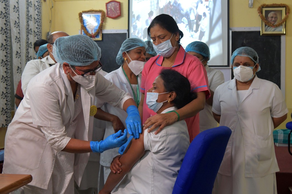 A medical worker inoculates a colleague with a Covid-19 vaccine at the KC General Hospital on Saturday in Bangalore, India. Photo: AFP