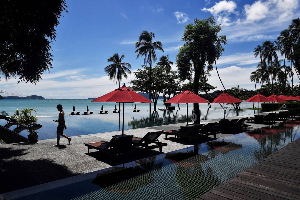 A lone customer walks past a swimming pool at the Vijitt Resort in Phuket, Thailand. File photo: AFP