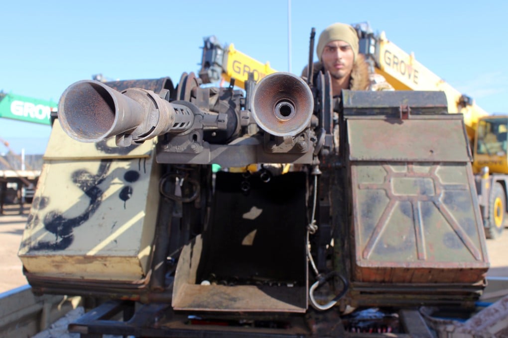 A member of the Libyan internationally recognised government forces heads out to the front line atop a military vehicle from Misrata, Libya in February 2020. Photo: Reuters
