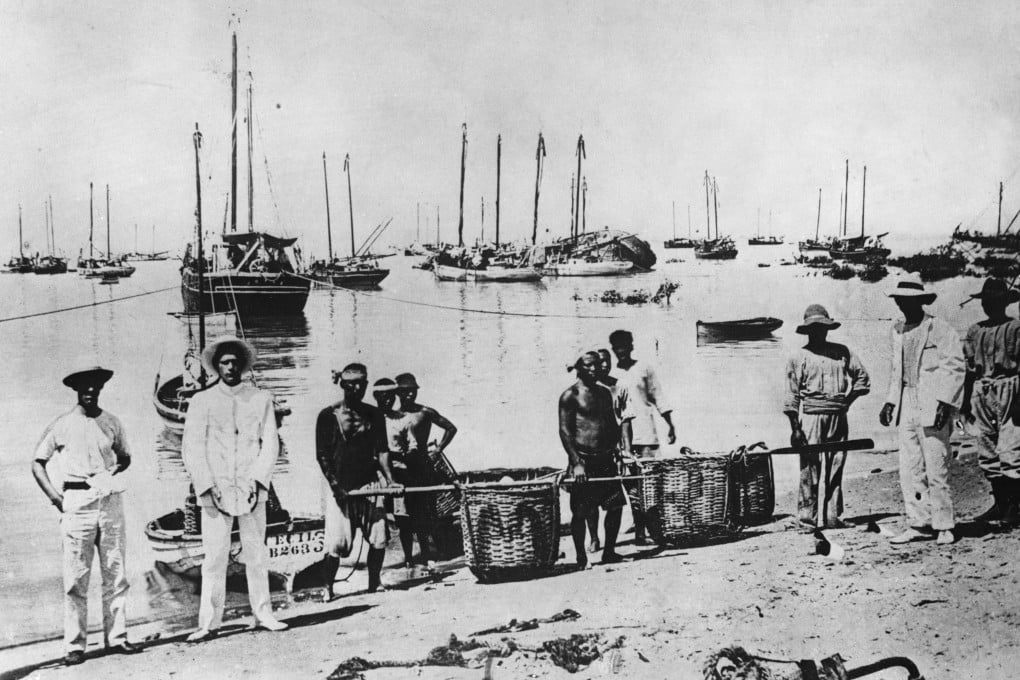 Men carry baskets of mother-of-pearl onto a beach in Broome, Western Australia. Photo: Getty Images