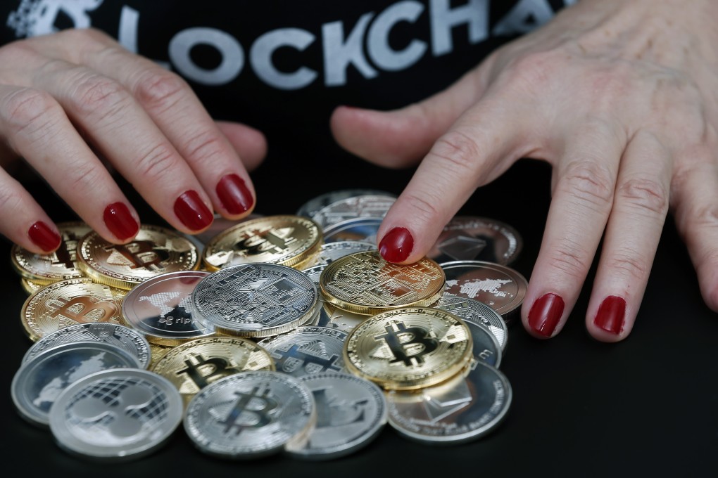 Visual representations of various cryptocurrencies on display in Paris, France. Photo: Getty Images
