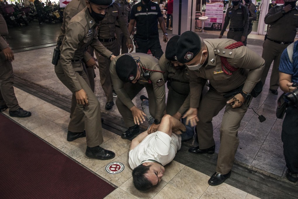 Thai police arrest a man during an anti-government protest in Bangkok on Saturday calling for democratic reforms and the resignation of Prime Minister Prayuth Chan-ocha. Photo: DPA
