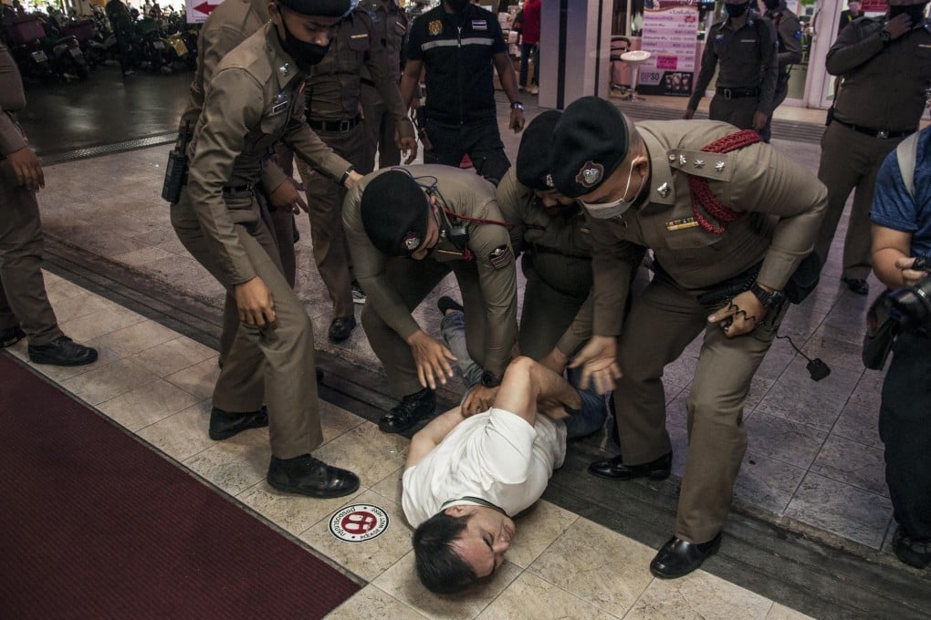 Thai police arrest a man during an anti-government protest in Bangkok on Saturday calling for democratic reforms and the resignation of Prime Minister Prayuth Chan-ocha. Photo: DPA