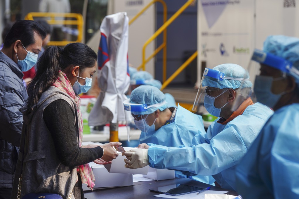 Residents sign up for Covid-19 screening at a mobile testing point in Jordan. Photo: Sam Tsang