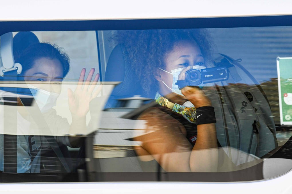 Japan’s Naomi Osaka takes a video from inside a car after returning to her hotel in Melbourne from a training session. Photo: AFP