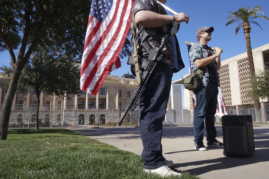 Members of the far-right Boogaloo Boys group stand in front of the Arizona State Capitol building in Phoenix on Sunday. Photo: AFP