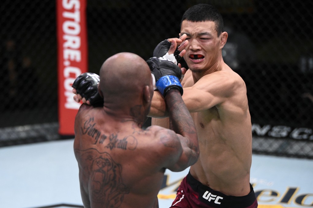 Su Mudaerji punches Malcolm Gordon in their flyweight bout at the UFC Fight Night at UFC Apex in Las Vegas on November 28, 2020. Photo: Chris Unger/Zuffa LLC