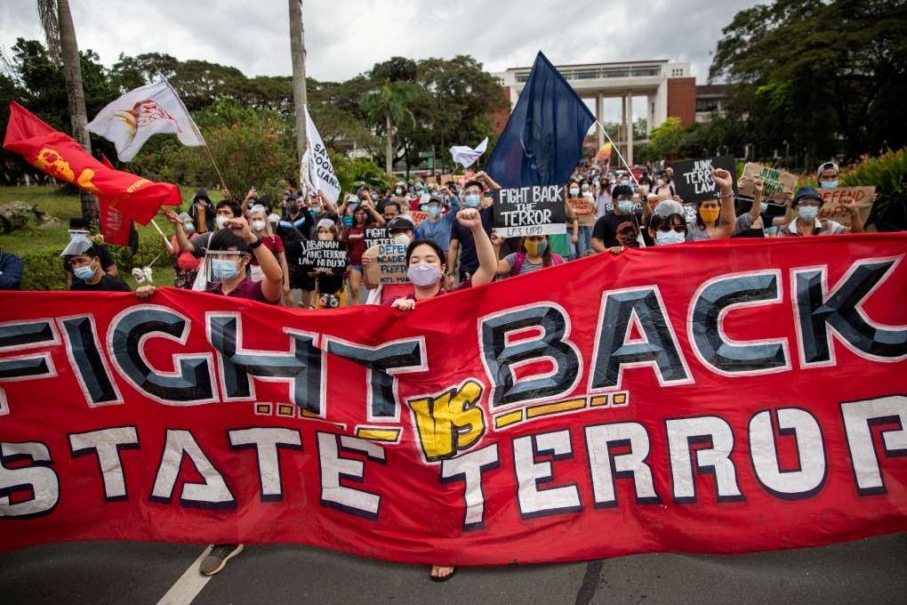 Students and activists at the University of the Philippines march in protest against the defense ministry's cancellation of a decades-long pact preventing police and soldiers from entering the campus. Photo: Reuters