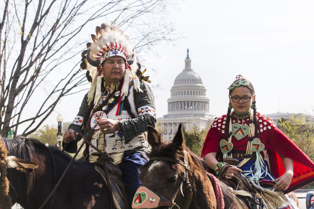 Shane Red Hawk of the Sicangu Lakota band of the Rosebud Sioux and his daughter Tshina Red Hawk prepare to begin a horseback ride Washington in April 2014 in protest against the Keystone XL pipeline. Photo: EPA