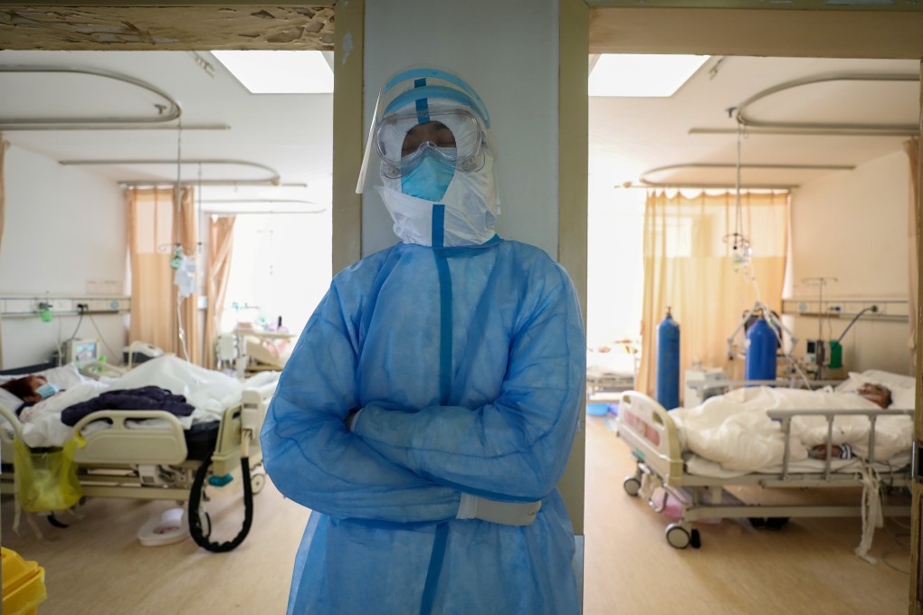 A medical worker in protective suit takes a break at the Wuhan Red Cross Hospital in February 2020. Photo: China Daily via Reuters