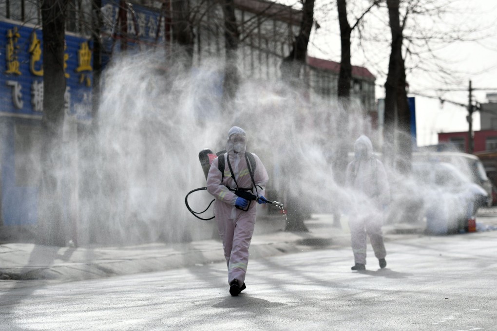 Disinfectant is sprayed on a street in Shijiazhuang, one of the cities locked down this month as China tries to contain its latest outbreaks. Photo: AFP