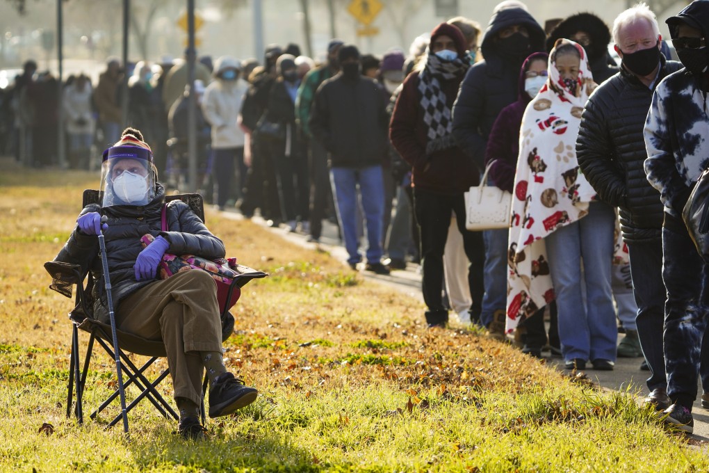 Florence Mullins, 89, sits in a chair as a family member holds her place in a queue to receive a Covid-19 vaccine at Fair Park in Dallas on January 11. Photo: AP