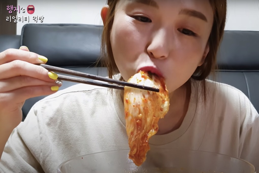 South Korean social media influencer Hamzy eating kimchi in a YouTube video. Chinese social media sites have banned Hamzy after she gave a thumbs-up emoji to a comment critical of China for claiming to be the origin of the dish. Photo: YouTube/Hamzy