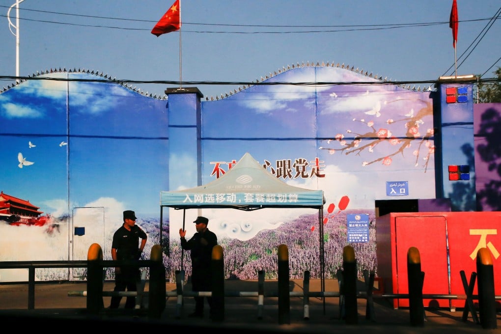 Security guards stand at the gates of what is officially known as a vocational skills education centre in Xinjiang in September 2018. Photo: Reuters