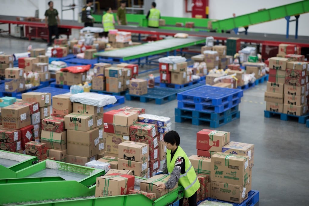 Workers in a Tmall warehouse gather orders from customers in Jiangmen, Guangdong province, on November 28, 2018. Alibaba’s Tmall and JD.com have been boosting their platforms for overseas brands as consumer goods imports surge in China during the coronavirus pandemic. Photo: EPA-EFE