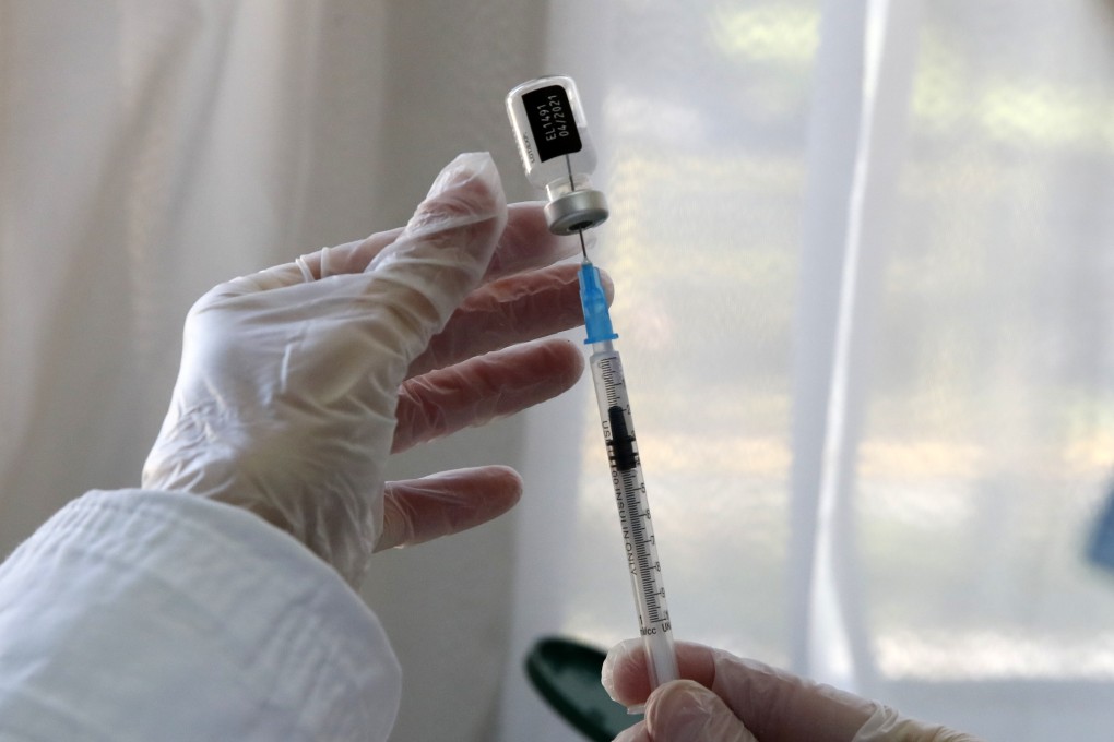 A nurse prepares a dose of coronavirus vaccine. A Japanese official has denied reports that a mass jab roll-out is set to begin in May. Photo: AP