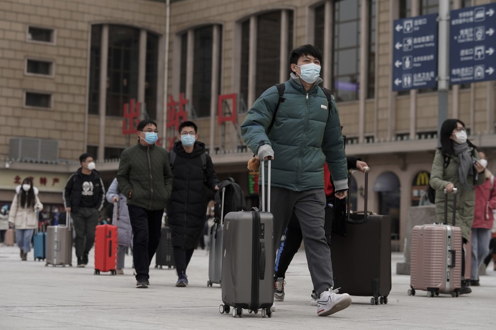 Passengers at Beijing’s main railway station on Tuesday. Photo: AP