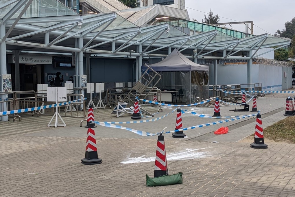 A black-clad group recently charged Chinese University’s security barrier and threw an unknown powder at security guards. Photo: SCMP