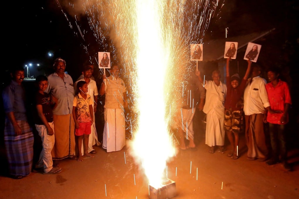 Villagers in Thulasendrapuram, India hold posters of Kamala Harris and set off pyrotechnics to celebrate her swearing-in as US vice-president. Photo: Reuters