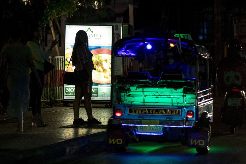 Sex workers stand in a largely shut-down red light area in Bangkok in March after a state of emergency was declared. Photo: AP