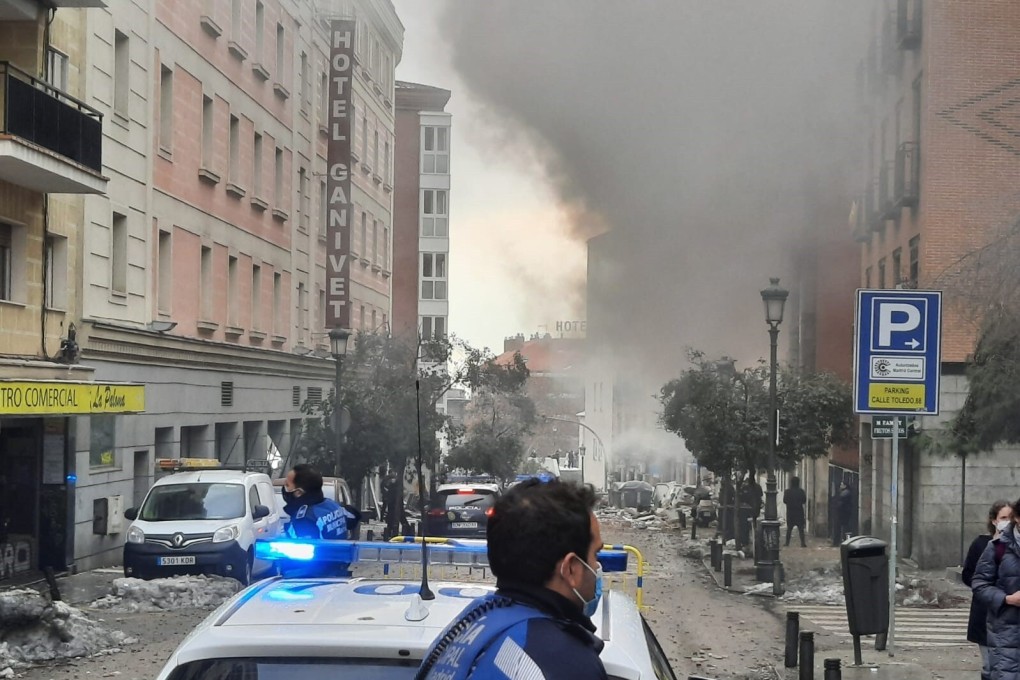 A police officer attends the scene after an explosion destroyed a building in Madrid on Wednesday.