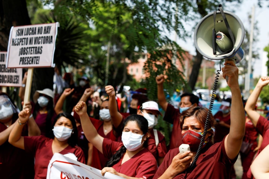 Health workers protest while going on an indefinite strike as they demand a better national health budget and access to vaccines, in Lima, Peru. Photo: Reuters