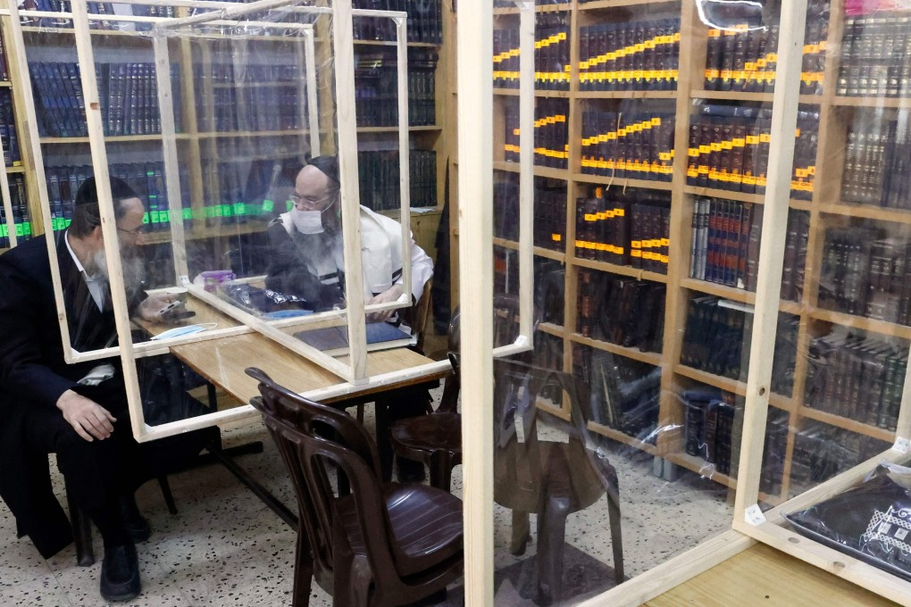 Ultra-Orthodox Jewish men study inside a synagogue in Bnei Brak, Israel. Photo: AFP