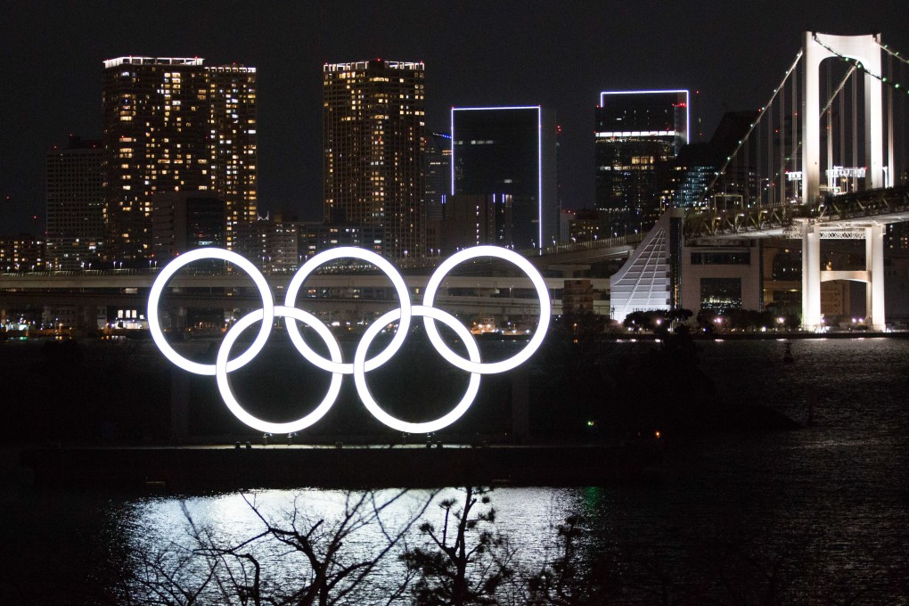 The giant Olympic Rings installation is illuminated in Odaiba Marine Park at night. Photo: DPA