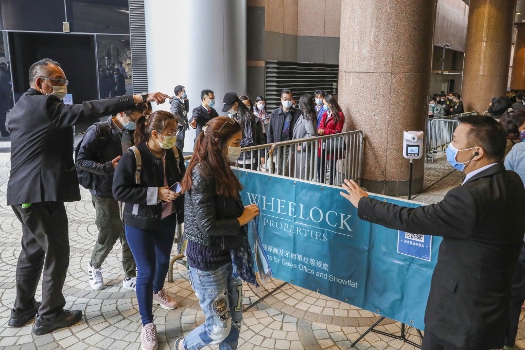 Potential buyers line up at the sales office for flats at the Monaco development in Kai Tak. Photo: Nora Tam