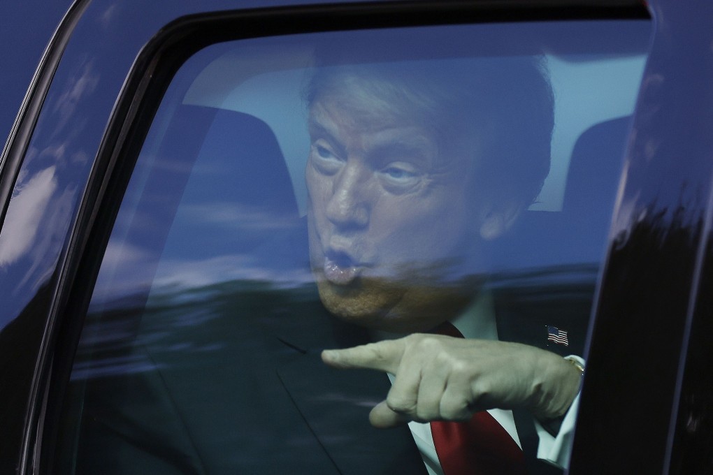 Donald Trump waves to supporters lined along on the route to his Mar-a-Lago estate after leaving the presidency. Photo: AFP