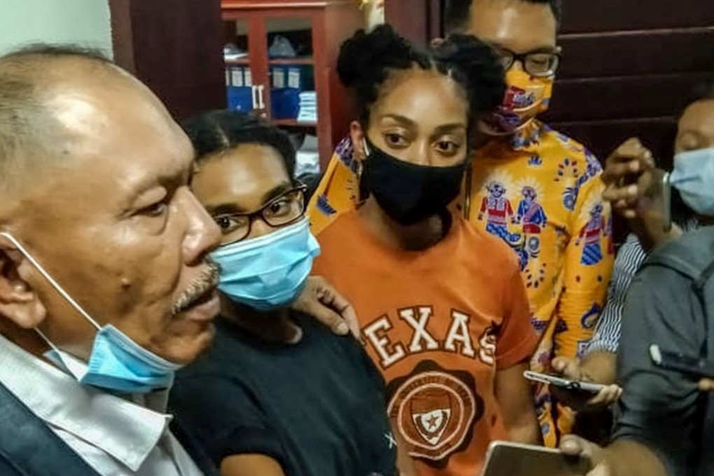 Kristen Gray, second left, and her partner listening to their lawyer while meeting journalists in Denpasar, after Gray was marked for deportation. Photo: AFP