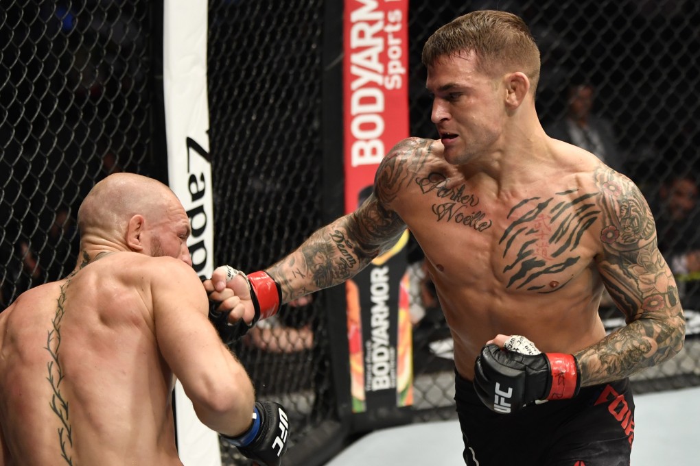 Dustin Poirier punches Conor McGregor in their lightweight main event at UFC 257. Photo: Jeff Bottari/Zuffa LLC