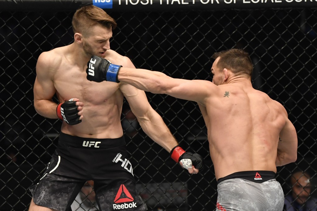 Michael Chandler punches Dan Hooker in their lightweight fight during UFC 257. Photos: Jeff Bottari/Zuffa LLC