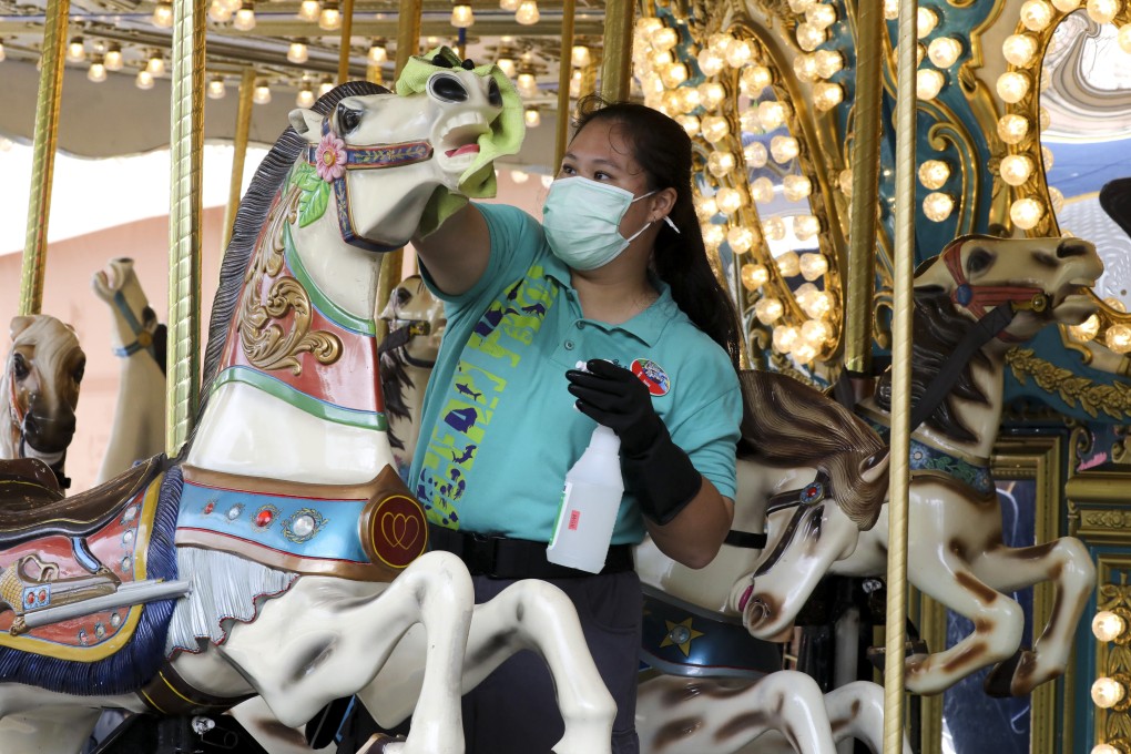 An employee disinfects an Ocean Park roundabout on September 18, 2020, after the theme park reopened following the easing of Covid-19 social distancing rules in Hong Kong. It had to shut again in December amid a resurgence in cases. Photo: K.Y. Cheng