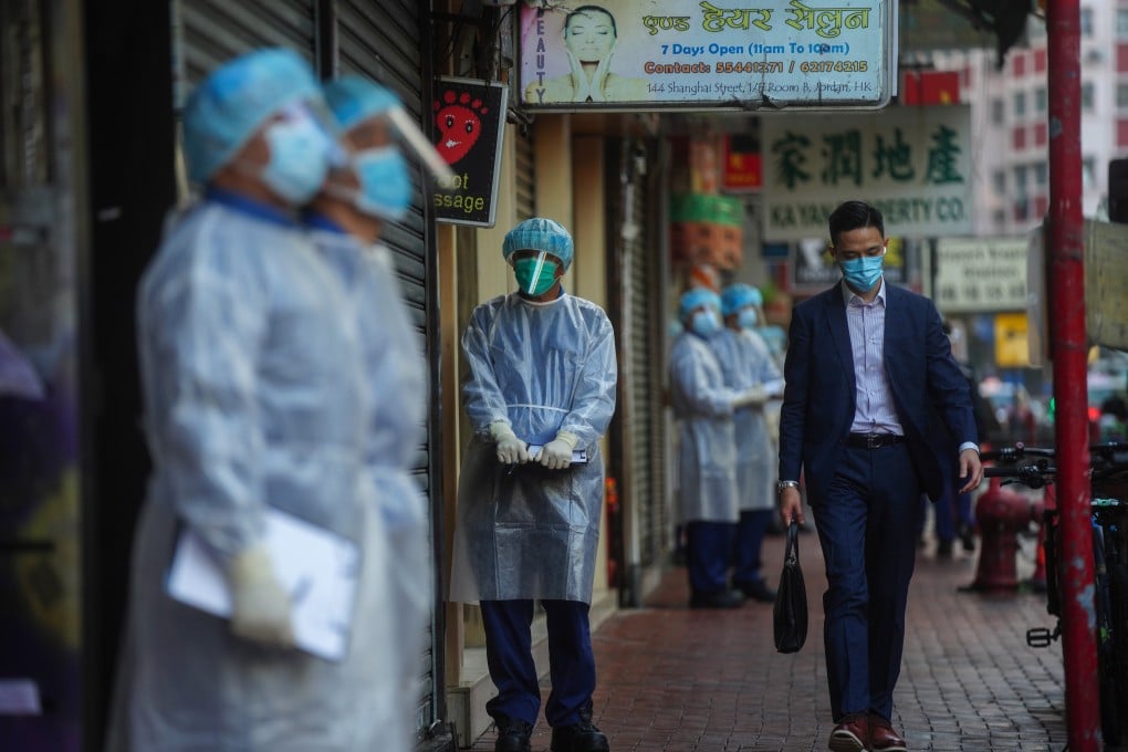 Government workers remained in the streets of a Yau Ma Tei neighbourhood on Monday after the lockdown was lifted. Photo: Sam Tsang