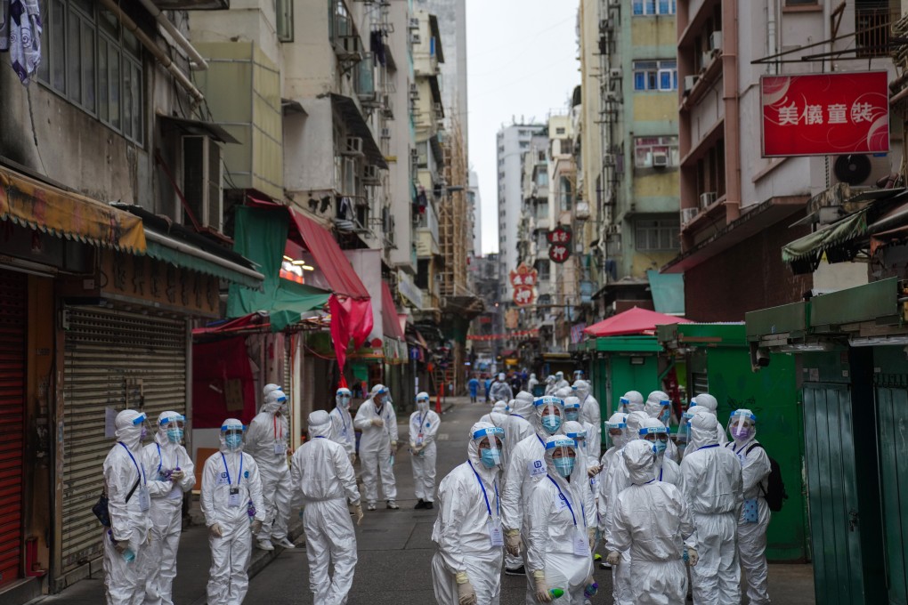 Government workers in protective gear carry out the mass Covid-19 screening operation in Yau Tsim Mong. Photo: Sam Tsang