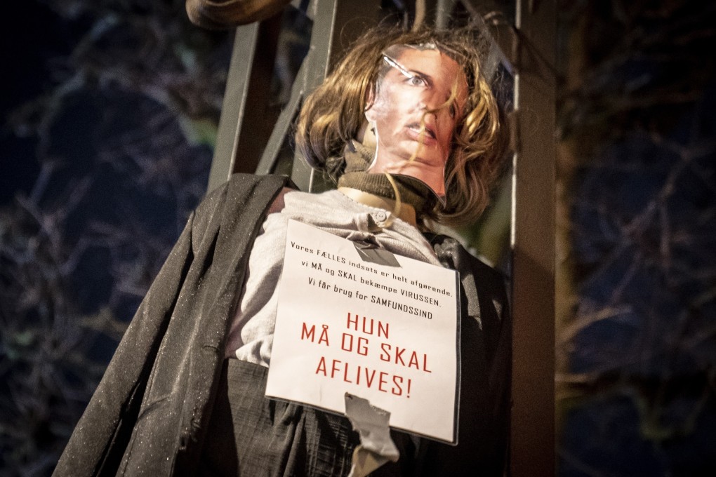 An effigy representing Danish Prime Minister Mette Frederiksen with a sign around her neck reading “She must be put down” is pictured before being set alight in Copenhagen, Denmark on Sunday. Photo: EPA-EFE