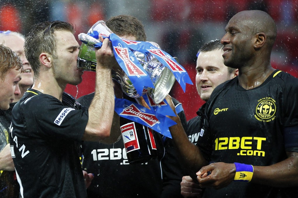 Callum McManaman (left) leads Wigan Athletic celebrations after beating Manchester City in the 2013 FA Cup final at Wembley. Photo: Xinhua