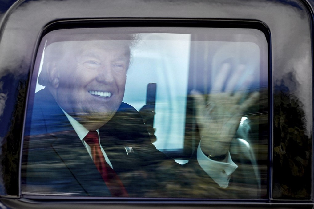 Former president Donald Trump waves to supporters as his motorcade drives through West Palm Beach, Florida. File photo: AP