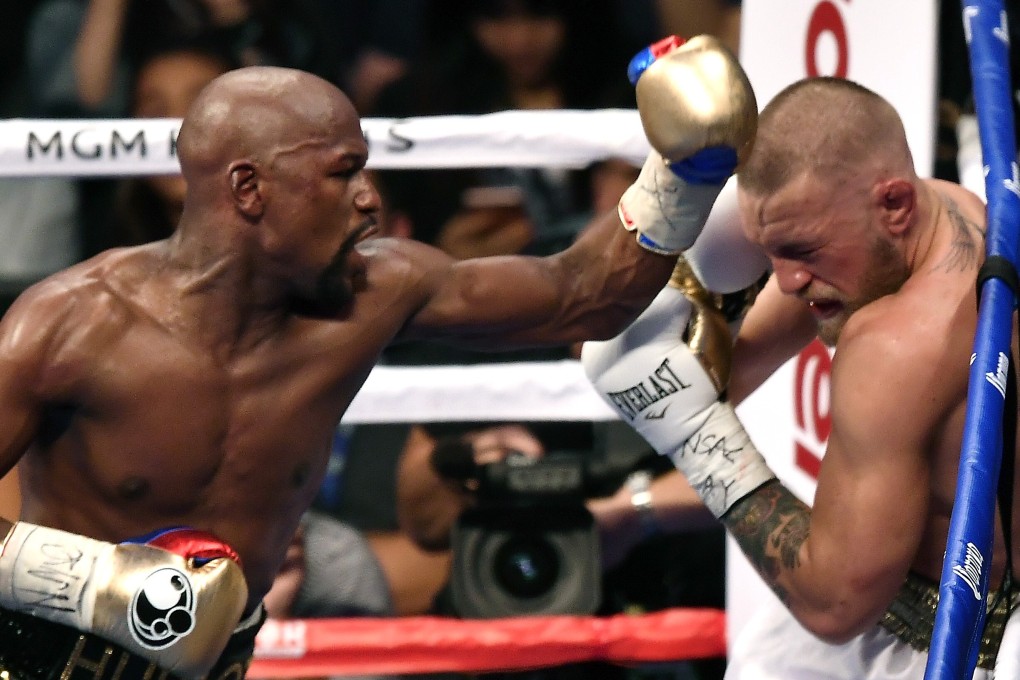 Retired boxer Floyd Mayweather Jnr punches MMA star Conor McGregor in their super welterweight boxing crossover fight at the T-Mobile Arena, Las Vegas in 2017. Photo: Zuffa LLC
