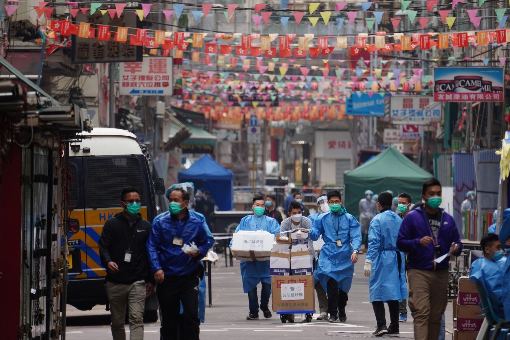 Hong Kong government staff arrive with supplies on the second day of the localised lockdown in Yau Ma Tei, on January 24. Photo: Robert Ng